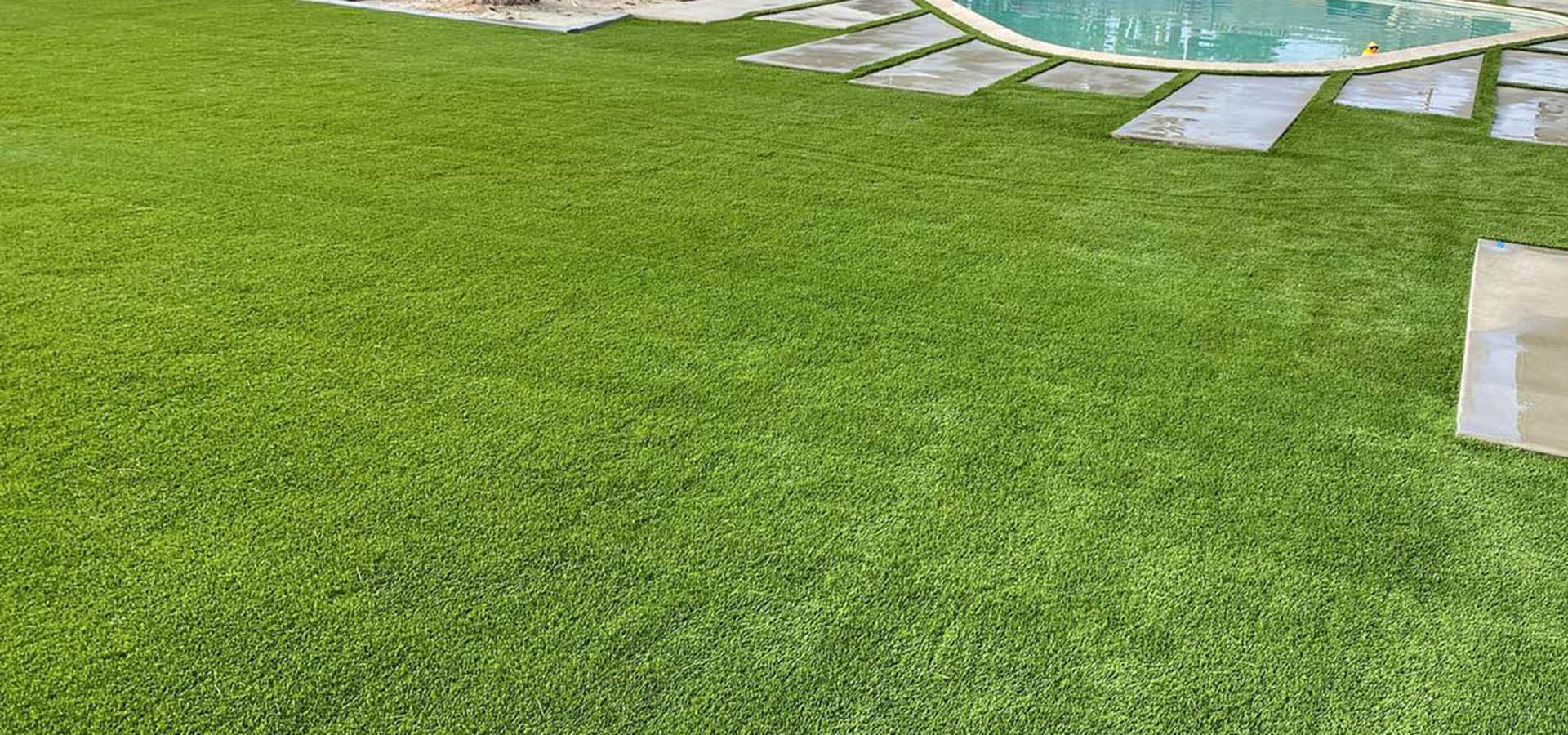 Finished OSC landscape with turf, pool, and stonework